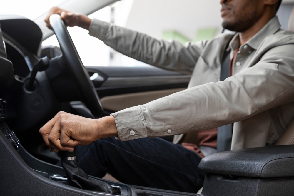African american man driving his car shifting gears